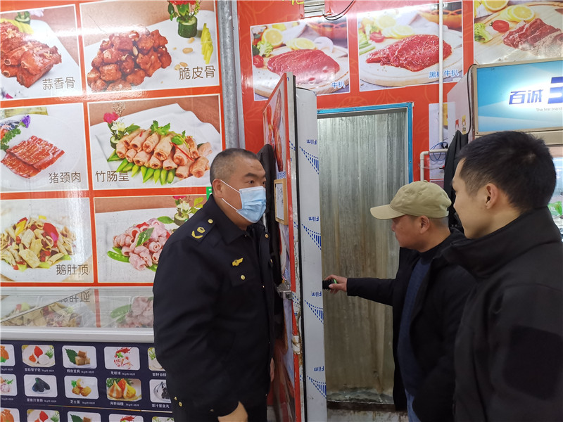 执法人员在西联市场检查冻库使用情况.jpg
