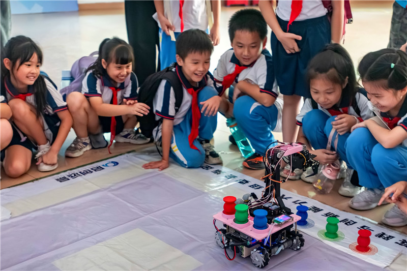 孩子们观看大学生自研物流搬运车运作过程.jpg